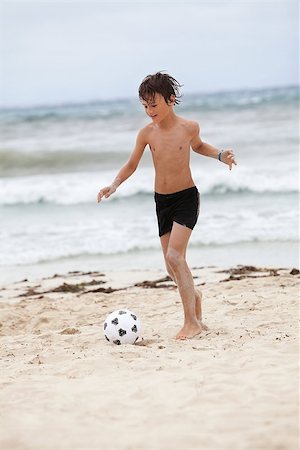 father and son playing football at beach - happy family father two kids playing football on beach summer fun soccer Stock Photo - Budget Royalty-Free & Subscription, Code: 400-07478084