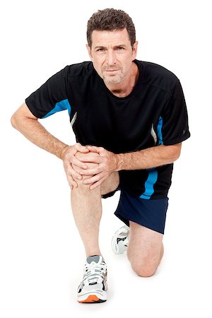 adult attractive man in sportswear knee pain injury ache isolated on white Stock Photo - Budget Royalty-Free & Subscription, Code: 400-07478212