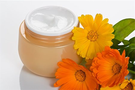 Cosmetic moisturizing facial and body cream in jar with flower Fotografie stock - Microstock e Abbonamento, Codice: 400-07478829