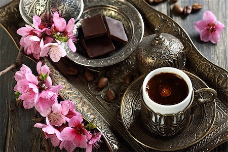 Turkish coffee and a branch with pink flowers on an old table. Photographie de stock - Aubaine LD & Abonnement, Code: 400-07478839