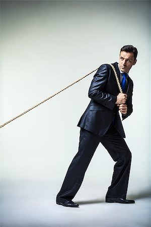 Man in suit pulling a rope Stock Photo - Budget Royalty-Free & Subscription, Code: 400-07479756