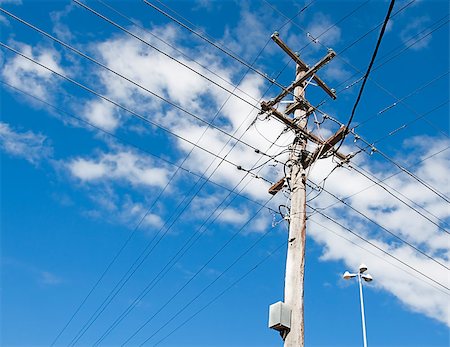 Australian electricity grid with power pole and power lines against blue sky Stock Photo - Budget Royalty-Free & Subscription, Code: 400-07470691