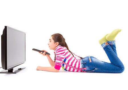 Happy little girl laying down and watching tv Stock Photo - Budget Royalty-Free & Subscription, Code: 400-07470918
