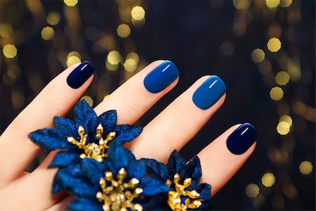 Manicure on women s hands are covered with blue lacquer two tones with flowers Stock Photo - Budget Royalty-Free & Subscription, Code: 400-07471249