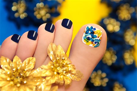 Blue pedicure with butterflies in white lacquer big toe with Golden flowers Stock Photo - Budget Royalty-Free & Subscription, Code: 400-07471250