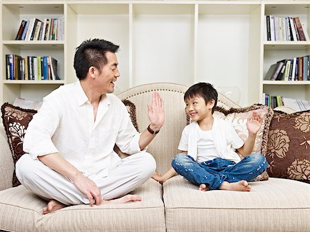 simsearch:400-04563959,k - father and son having a conversation on couch at home. Photographie de stock - Aubaine LD & Abonnement, Code: 400-07471284