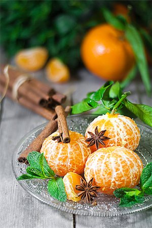 Ripe tangerines without peel with anise star, cinnamon and fresh mint. Limited focus. Stock Photo - Budget Royalty-Free & Subscription, Code: 400-07472397