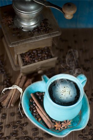 Coffee in the teal mug and old teal mill with cinnamon and star anise. Selective focus. Stock Photo - Budget Royalty-Free & Subscription, Code: 400-07472399