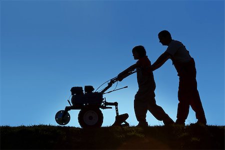 Silhouettes of father and son working the land with a tiller - small scale organic farming concept Stock Photo - Budget Royalty-Free & Subscription, Code: 400-07472392