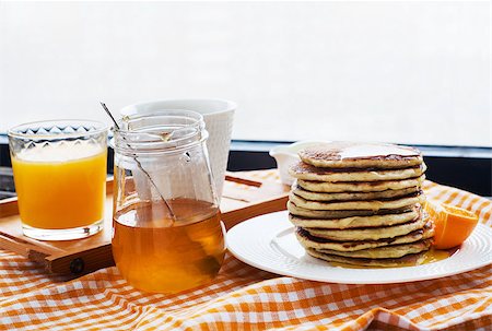 simsearch:400-07917638,k - Breakfast with pancakes, coffee, honey and juice on table at the window Stock Photo - Budget Royalty-Free & Subscription, Code: 400-07472499