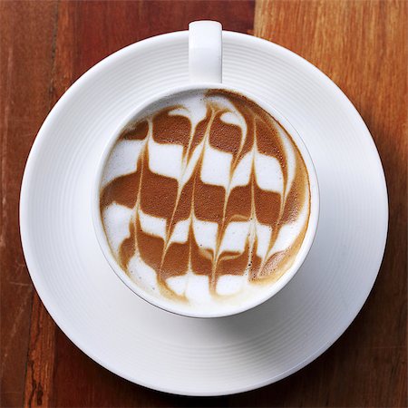 simsearch:400-04546601,k - Cup of latte coffee on the wooden desk Foto de stock - Royalty-Free Super Valor e Assinatura, Número: 400-07472778