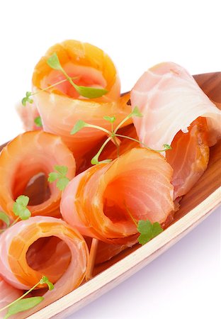 sturgeon - Snack of Swirled Slices of Delicious Smoked Sturgeon with Greens on Wooden Plate closeup on white background Stock Photo - Budget Royalty-Free & Subscription, Code: 400-07473096