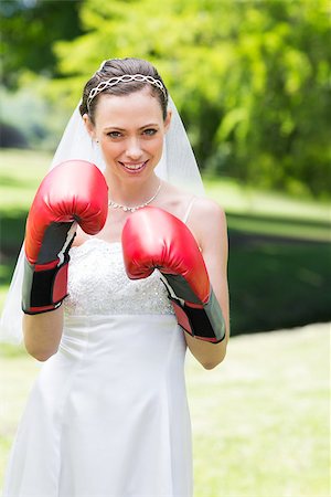 portrait of woman wearing boxing gloves - Portrait of young bride wearing boxing gloves in garden Stock Photo - Budget Royalty-Free & Subscription, Code: 400-07473189