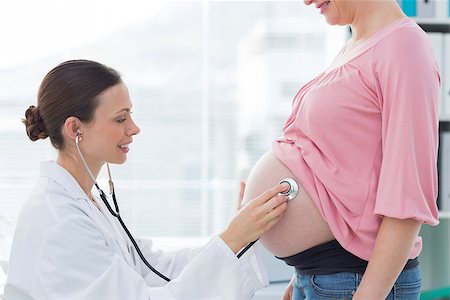 Side view of female doctor examing expectant woman in clinic Stock Photo - Budget Royalty-Free & Subscription, Code: 400-07473265