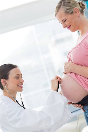 Female doctor examining stomach of pregnant woman in clinic Stock Photo - Budget Royalty-Free & Subscription, Code: 400-07473266