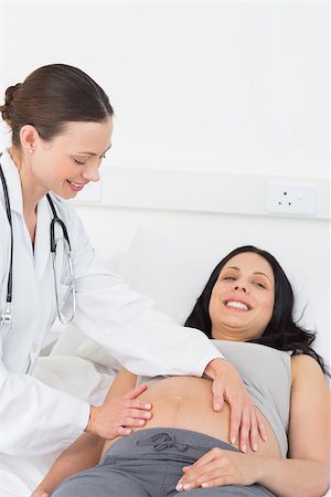 Portrait of happy expectant woman being checked by female doctor in hospital Stock Photo - Budget Royalty-Free & Subscription, Code: 400-07473331