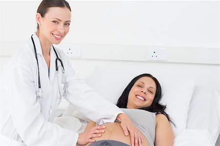 Portrait of beautiful doctor checking expectant woman in examination room at hospital Stock Photo - Budget Royalty-Free & Subscription, Code: 400-07473332
