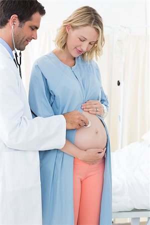 Male doctor checking belly of pregnant woman with stethoscope in hospital ward Stock Photo - Budget Royalty-Free & Subscription, Code: 400-07473356