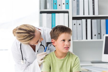 simsearch:400-06734741,k - Boy being examined by female pediatrician with otoscope in clinic Photographie de stock - Aubaine LD & Abonnement, Code: 400-07473514