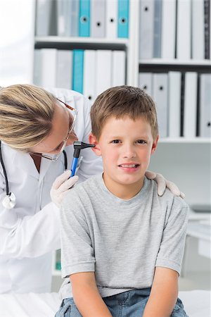 simsearch:400-06734647,k - Portrait of boy being examined by pediatrician with otoscope in clinic Stock Photo - Budget Royalty-Free & Subscription, Code: 400-07473513