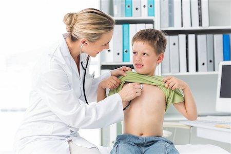 simsearch:400-06734647,k - Female doctor examining boy with stethoscope in clinic Stock Photo - Budget Royalty-Free & Subscription, Code: 400-07473525