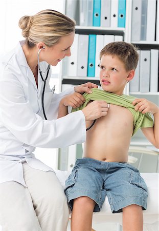 simsearch:400-06734647,k - Female pediatrician examining boy with stethoscope in clinic Stock Photo - Budget Royalty-Free & Subscription, Code: 400-07473526