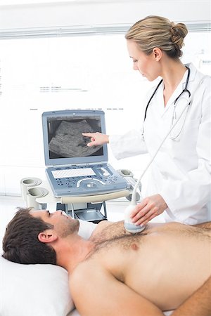 photo of patient in hospital in usa - Female doctor using sonogram on male patient in examination room Stock Photo - Budget Royalty-Free & Subscription, Code: 400-07473544