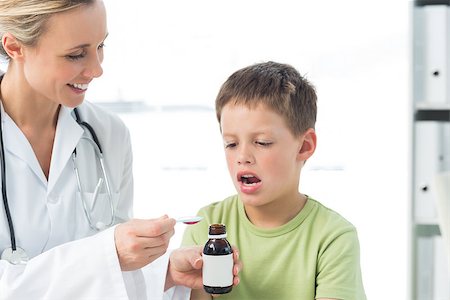 female coughing - Female doctor giving little boy cough syrup in hospital Stock Photo - Budget Royalty-Free & Subscription, Code: 400-07473541