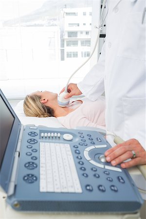 simsearch:400-07474040,k - Male doctor performing ultrasound scan on neck of female patient Stock Photo - Budget Royalty-Free & Subscription, Code: 400-07473550