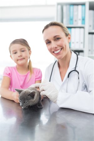 Portrait of female veterinary and girl with kitten in clinic Stock Photo - Budget Royalty-Free & Subscription, Code: 400-07473633