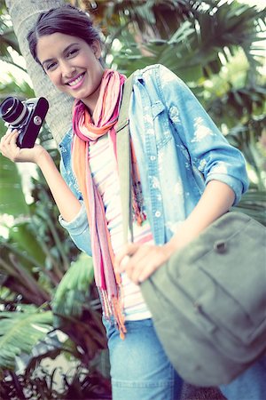 Happy photographer standing outside smiling at camera on a sunny day Stock Photo - Budget Royalty-Free & Subscription, Code: 400-07473759