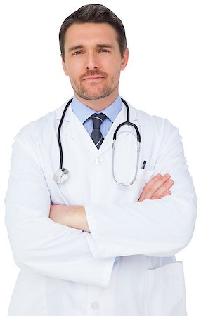 simsearch:400-04217553,k - Handsome young doctor with arms crossed on white background Foto de stock - Royalty-Free Super Valor e Assinatura, Número: 400-07484208