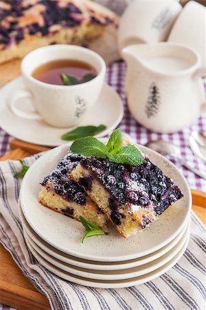 simsearch:400-07295671,k - Portion of fresh homemade blueberry cake and cup of tea on the background Photographie de stock - Aubaine LD & Abonnement, Code: 400-07485797