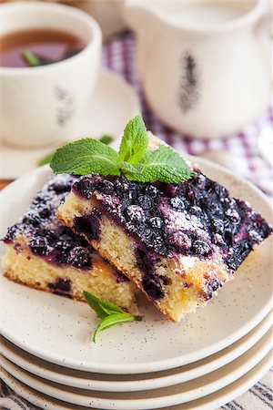 simsearch:400-07295671,k - Portion of fresh homemade blueberry cake and cup of tea on the background Photographie de stock - Aubaine LD & Abonnement, Code: 400-07485799