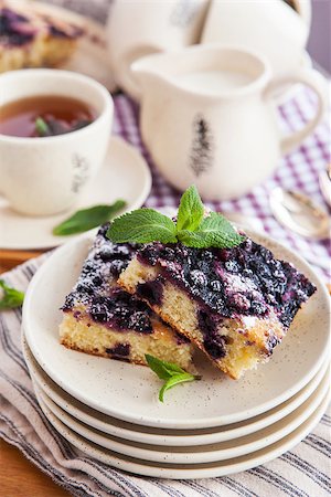 simsearch:400-07295671,k - Portion of fresh homemade blueberry cake and cup of tea on the background Photographie de stock - Aubaine LD & Abonnement, Code: 400-07485800