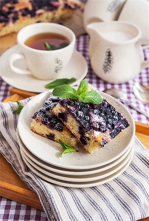 simsearch:400-07295671,k - Portion of fresh homemade blueberry cake and cup of tea on the background Photographie de stock - Aubaine LD & Abonnement, Code: 400-07486319