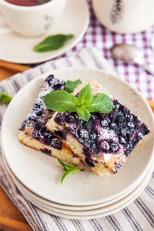 simsearch:400-07295671,k - Portion of fresh homemade blueberry cake and cup of tea on the background Photographie de stock - Aubaine LD & Abonnement, Code: 400-07486320