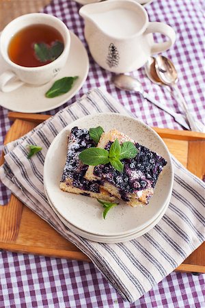 simsearch:400-07295671,k - Portion of fresh homemade blueberry cake and cup of tea on the background Photographie de stock - Aubaine LD & Abonnement, Code: 400-07486321