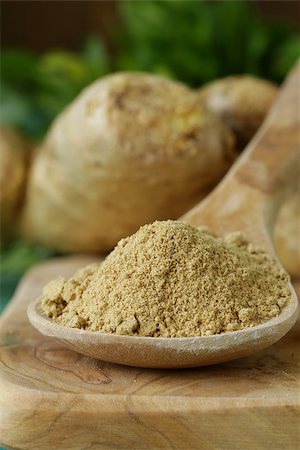 ground ginger in a wooden spoon, fresh root in the background Stock Photo - Budget Royalty-Free & Subscription, Code: 400-07486341