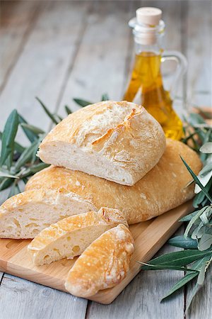 Italic traditional berad chiabatta with bottle of olibe oil and olive branch Stock Photo - Budget Royalty-Free & Subscription, Code: 400-07486422