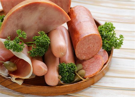 simsearch:400-06063216,k - various kinds of sausages and smoked bacon on the wooden plate Fotografie stock - Microstock e Abbonamento, Codice: 400-07486467