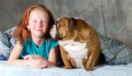 girl with her pet bulldog in bed Stock Photo - Budget Royalty-Free & Subscription, Code: 400-07480801