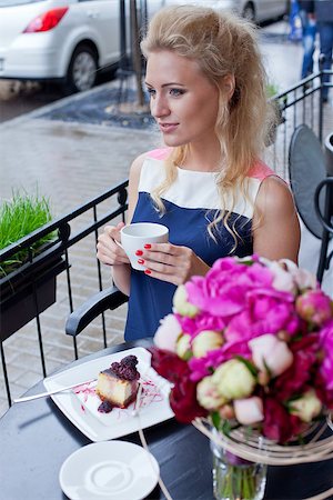 a beautiful young blond girl in summer dress at the table in pavement cafe holding a tea cup is looking thoughtfully in the distance Stock Photo - Budget Royalty-Free & Subscription, Code: 400-07481369