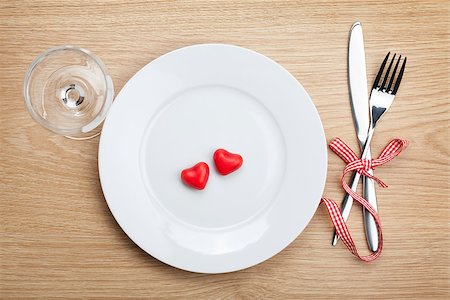 Valentine's Day heart shaped candy over plate with silverware and wine glass. On wooden table background Stock Photo - Budget Royalty-Free & Subscription, Code: 400-07481740