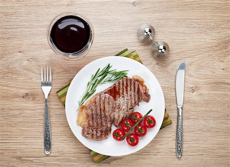 steak knife - Sirloin steak with rosemary and cherry tomatoes on a plate with wine. View from above Stock Photo - Budget Royalty-Free & Subscription, Code: 400-07481778