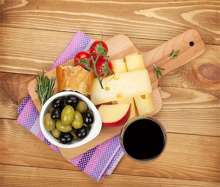 Red wine with cheese, bread, olives and spices. Over wooden table background. View from above Stock Photo - Budget Royalty-Free & Subscription, Code: 400-07481827