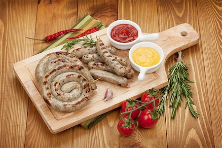 Grilled sausages with ketchup and mustard. Over wooden table background Stock Photo - Budget Royalty-Free & Subscription, Code: 400-07481854