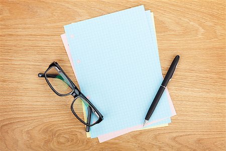 simsearch:400-07481880,k - Blank lined paper with office supplies and glasses on wooden table. Above view Fotografie stock - Microstock e Abbonamento, Codice: 400-07481877