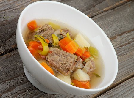 simsearch:400-07478286,k - Rustic Beef Soup with Potato, Carrot, Leek and Greens in White Bowl closeup on Wooden background Stock Photo - Budget Royalty-Free & Subscription, Code: 400-07482754