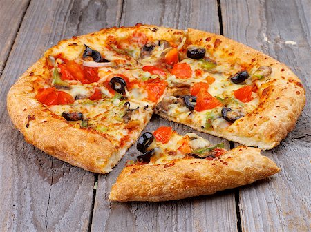 simsearch:400-07420117,k - Full Body and Slice of Vegetarian Pizza with Tomatoes, Black Olives and Cheese on Rustic Wooden background Stock Photo - Budget Royalty-Free & Subscription, Code: 400-07482757